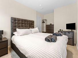 A bedroom with a bed and towels on the bed at Hafan Rhos in Rhos-On-Sea