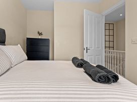 A bedroom with a bed and towels on it at Hafan Rhos in Rhos-On-Sea