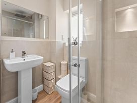 A bathroom with sink, toilet, and shower at Hafan Rhos, Rhos-On-Sea