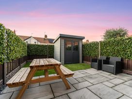 A garden with a shed and seating area at Hafan Rhos in Rhos-On-Sea