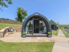 An outdoor area with a pod and seating at Ogden in Nelson