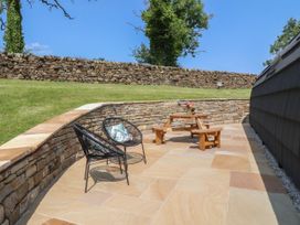 An outdoor area with seating and a stone wall at Ogden in Nelson