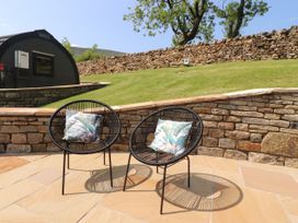 Two chairs with cushions in a garden area at Ogden in Nelson