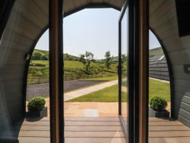 An outdoor view from a pod looking at the pathway and landscape at Ogden in Nelson