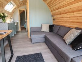 A living room with a couch and kitchenette at Ogden in Nelson