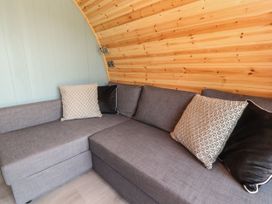 A sitting room with a gray sofa and cushions at Ogden in Nelson