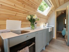 A kitchen with a sink and flowers at Ogden in Nelson