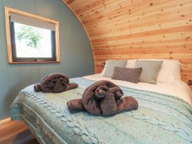 A bedroom with a bed and decorative towels at Ogden in Nelson