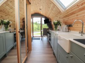A kitchen with sink and dining table at Ogden in Nelson
