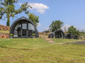 Four pods with chairs on a grassy area at Ogden in Nelson