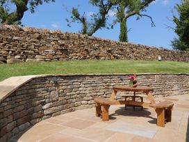 A wooden table and benches in an outdoor area at Pendle in Nelson
