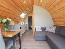 A living room with a kitchen area and dining table at Pendle in Nelson