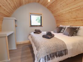 A bedroom with a bed and shelf at Pendle in Nelson