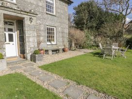 A house entrance with garden furniture at Bwthyn Morse in Llanfair