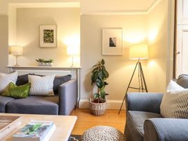 A living room with a couch and lamps at Bwthyn Morse in Llanfair