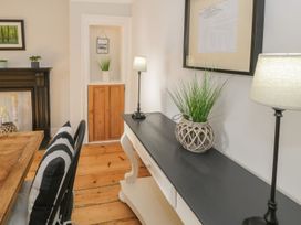 A dining room with a table and chairs at Bwthyn Morse in Llanfair