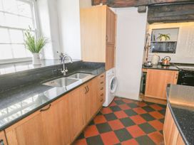 A kitchen with a sink and washing machine at Bwthyn Morse in Llanfair
