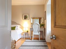 A bedroom with a bed and vanity at Bwthyn Morse in Llanfair