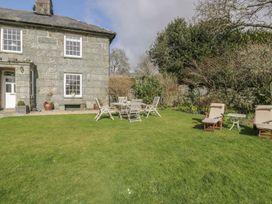 A garden with seating and a house at Bwthyn Morse in Llanfair