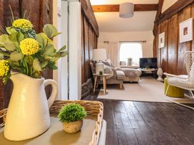 A living room with a couch and a television at Bwthyn Canol in Llanfair