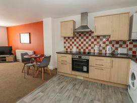 A kitchen with table and chairs at Curwen Apartment in Workington
