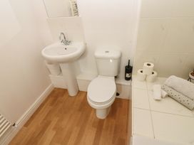 A bathroom with a toilet and sink at Curwen Apartment in Workington