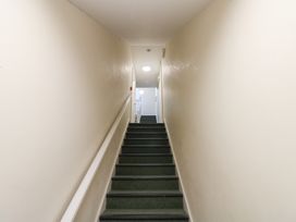A staircase with stairs and a handrail at Curwen Apartment in Workington