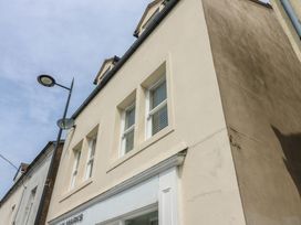 A building exterior with windows and a streetlight at Curwen Apartment in Workington