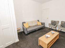 A living room with a sofa and chairs at Cumberland House in Workington