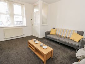 A living room with a sofa and coffee table at Cumberland House in Workington