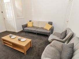 A living room with a sofa and coffee table at Cumberland House in Workington