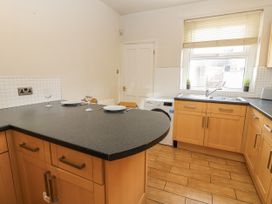A kitchen with countertop, sink, and appliances at Cumberland House in Workington