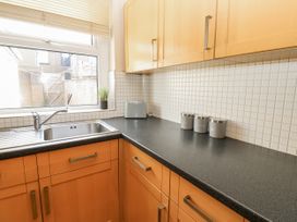 A kitchen with a sink and cabinet at Cumberland House in Workington