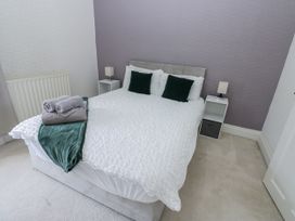 A bedroom with a bed and bedside tables at Cumberland House in Workington