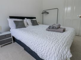 A bedroom with a bed and towels on it at Cumberland House in Workington
