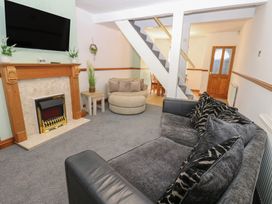A living room with a fireplace and television at Bolton Terrace in Workington