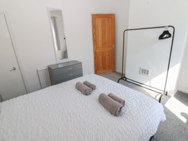 A bedroom with a bed and towels on it at Bolton Terrace in Workington