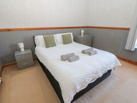 A bedroom with a bed and bedside tables at Bolton Terrace in Workington