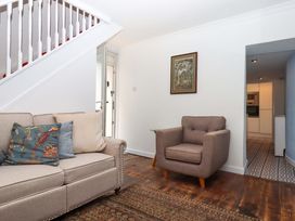 A living room with a sofa and chair at Kenny Cottage in Dawlish