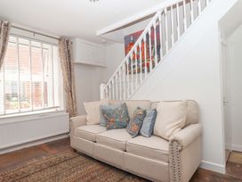 A living room with a sofa and rug at Kenny Cottage in Dawlish