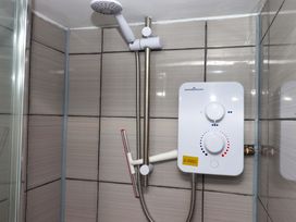 A shower system with a shower head and valve in Kenny Cottage Dawlish