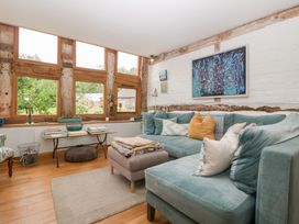 A living room with a sofa, table and artwork at The Art House in Leominster