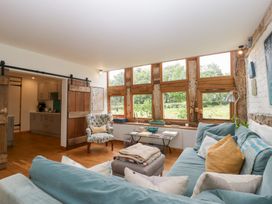 A living room with a sofa and armchair at The Art House in Leominster