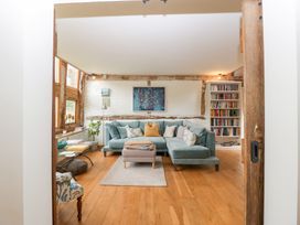 A living room with a sofa and bookshelf at The Art House in Leominster