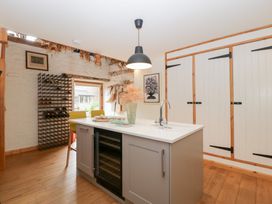 A kitchen with an island and wine rack at The Art House in Leominster