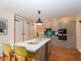 A kitchen with kitchen island and wall cabinets at The Art House in Leominster
