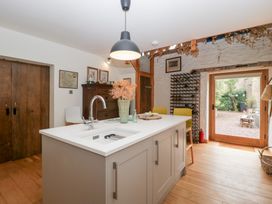 A kitchen with a sink and wooden cabinets at The Art House in Leominster