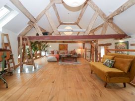 A loft with a sofa and coffee table at The Art House in Leominster