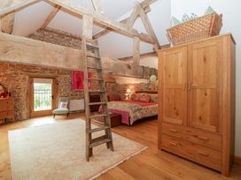 A bedroom with a bed and wardrobe at The Art House in Leominster
