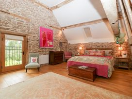 A bedroom with a bed, side tables, and a window at The Art House in Leominster